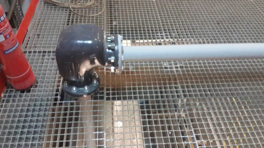Pneumatic conveying elbow installed in industrial pipework